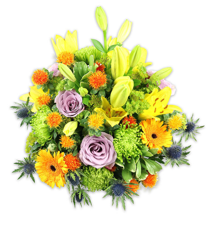 A richly textured, mounded floral arrangement is photographed against a stark white background so each hue and form reads with clarity. The composition is dominated by luminous yellow Asiatic lilies - some fully unfurled, showing freckled throats and stamens, others held as elegant chartreuse-yellow buds that extend the vertical lines of the design. Two or more powdery lavender roses sit centrally, their delicate, spiralling petals offering a cool, gentle focal point amid warmer tones. Interspersed are bold orange Gerbera daisies, their radiating petals and deeper centres like bright pockets of sunlight, while abundant lime-green 'button' or cushion chrysanthemums pack the arrangement with ruffled, almost moss-like texture. Scattered small, spherical orange-to-golden-yellow blooms provide concentrated sparks of colour and a slightly prickly, tactile contrast. Distinctive blue-grey sea thistles (Eryngium) protrude from the lower and lateral areas, their rigid, metallic-blue bracts and spiny forms creating an architectural outline that counterbalances the softer petals. A layered assortment of foliage - broad lily leaves, glossy fillers and feathery stems - unifies the palette and gives the bouquet depth and movement under gentle studio lighting.This bouquet evokes a sense of celebration and considered elegance, its scent a soft, sweet lily fragrance tempered by green freshness. As a florist who knows the rhythms of Sipson, from the village High Street to nearby Hatton Cross and Cranford, I imagine this arrangement both as a lively birthday gift and as a composed sympathy tribute - versatile, heartfelt, and made with hands that understand local tastes. The piece reads modern yet timeless, where colour, texture, and botanical surprises come together in expert harmony.
