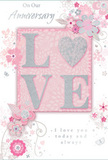 This anniversary card is styled with the same care a local florist might use while composing a romantic bouquet for a couple in Sipson. Across the centre, the word LOVE is showcased in generous, raised letters, their surfaces dusted with fine glitter that sparkles subtly in shades of soft pink and shimmering silver. The texture appears slightly embossed, inviting a gentle touch as light dances over each curve and edge. Where the letters rest, the background is a warm blush tone, deepening delicately toward the edges like the centre of a fully opened rose. Around this focal motif, a cascade of illustrated flowers in blush, mauve, and ivory flows outward, their petals and leaves drawn with the ease of a florist's pencil, curving naturally as if they might be lifted into a real arrangement. The blooms are interwoven with tiny butterflies, scrolling tendrils, and graceful flourishes that lend a feeling of movement, like a breeze passing through a spring garden near Sipson's quieter residential streets. Fine hints of silver foil on a few petals and stems pick up the light, giving depth to the otherwise soft, pastel design. In a refined script, phrases such as On Our Anniversary and I love you today and always appear, their flowing style echoing the lines of the vines and blossoms. The overall mood is tender and intimate, reminiscent of receiving a hand-delivered bouquet on an anniversary morning. It is a card that visually whispers devotion, perfect for marking a shared journey with quiet, enduring affection.